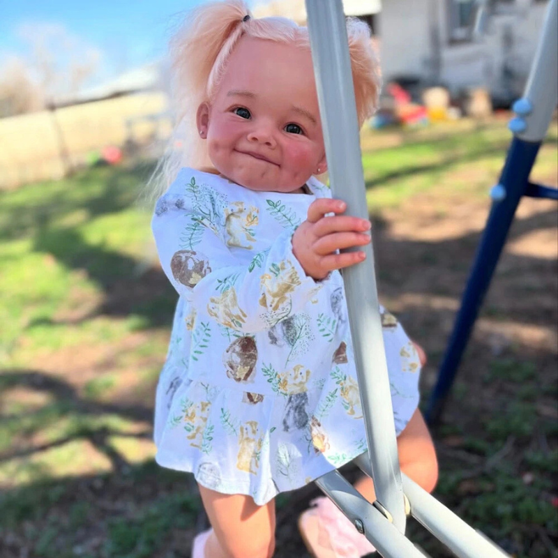 Sweet little girl doll sitting on a swing at a playground, with a happy and joyful expression, dressed in a cute outfit.