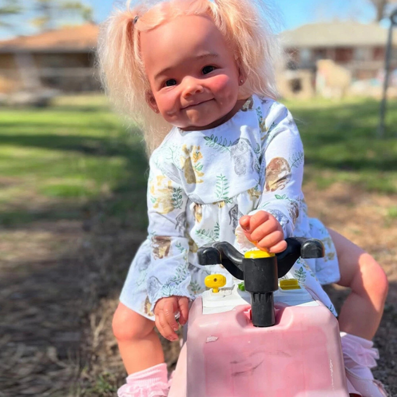 Stella Reborn Girl doll, 28 inches tall, handmade with love and tender realism, sitting in a toy stroller at a playground, with a sweet, gentle, and playful look, wearing a cute outfit