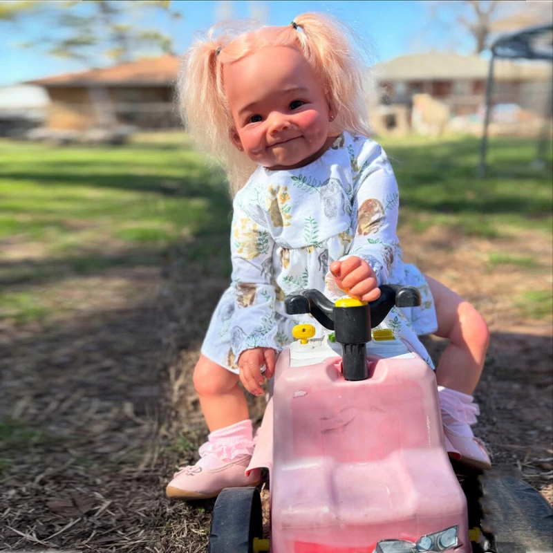 Stella Reborn Girl doll, 28 inches tall, handmade with love and tender realism, sitting in a toy stroller at a playground, wearing a cute outfit and smiling gently